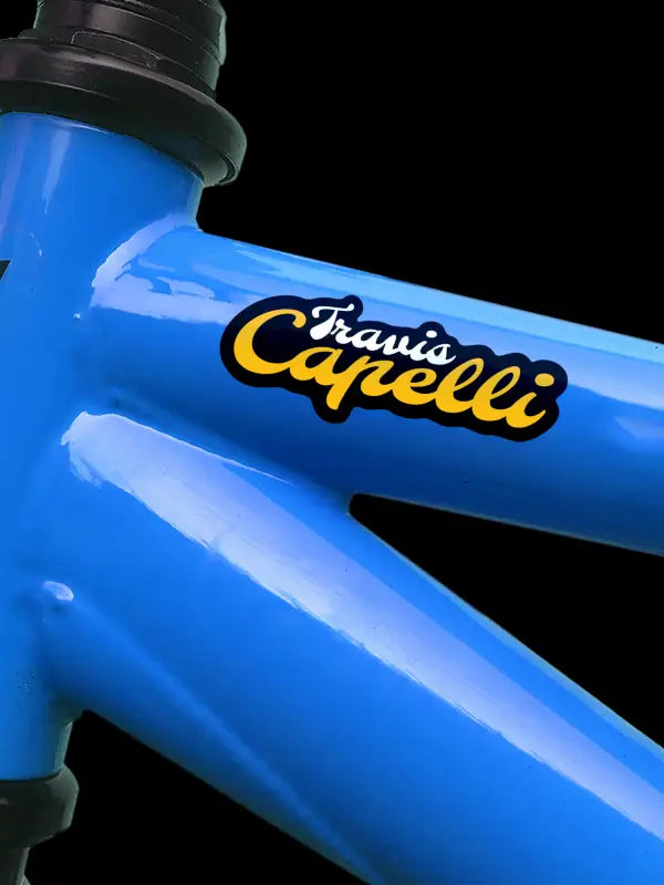 Personalised bike sticker neatly applied on metallic blue bike near headset.