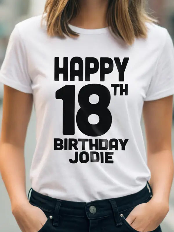 Lady wearing a white tee with “Happy 18th Birthday Jodie” printed large size in bold black iron on transfers.