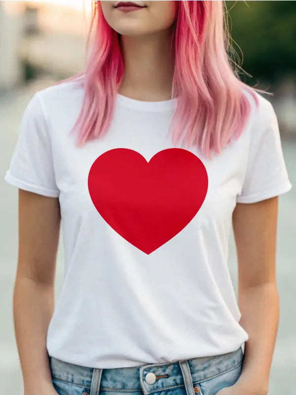 Close-up of woman in white shirt wearing a large red heart iron on transfer design.