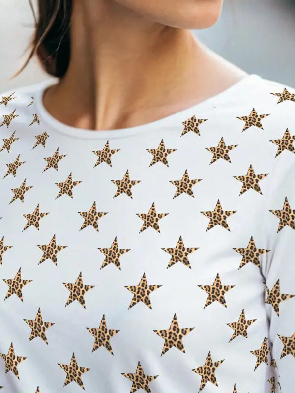 Lady wearing long-sleeved T-shirt fully covered in leopard star iron on transfers for bold fashion design.