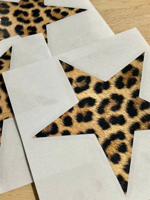 Close-up of leopard print star iron on transfers on backing paper ready to apply.