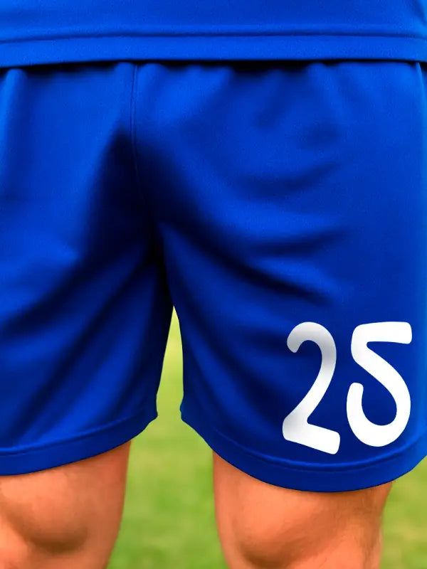 Goochi style number 25 in white iron on transfer applied to royal blue sports shorts, showing curved and fun lettering.