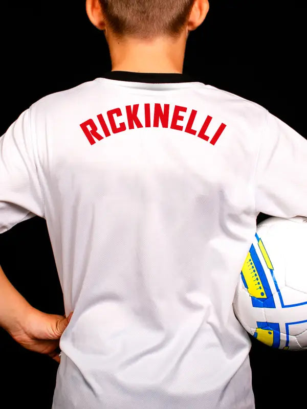 Iron on player name transfer in red showing RICKINELLI arched on white football shirt for professional look.