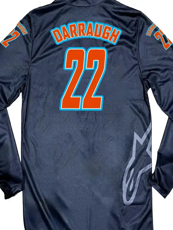Close-up of a black motocross jersey showing the name and number and arms  with Darraugh in bright orange and light blue iron on transfer.