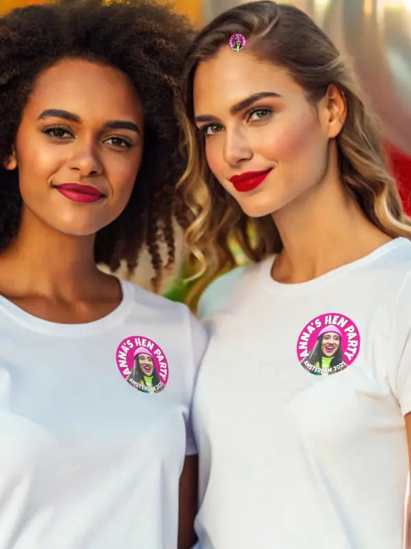 Two women smiling and wearing personalised hen party stickers on white t-shirts, ideal for group celebrations.
