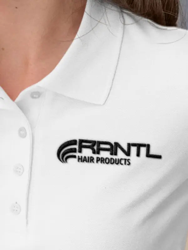 Close-up of a white polo shirt displaying a RANTL Hair Products chest logo applied with iron on business logo transfers.