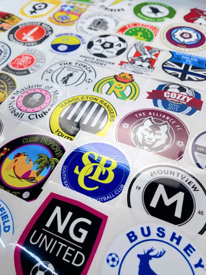 Assorted sports sponsor iron on transfers laid out for product visual reference