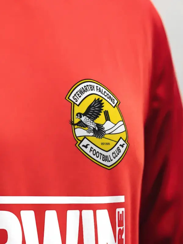 Stewartby Falcons club badge iron on transfer applied to red football kit.