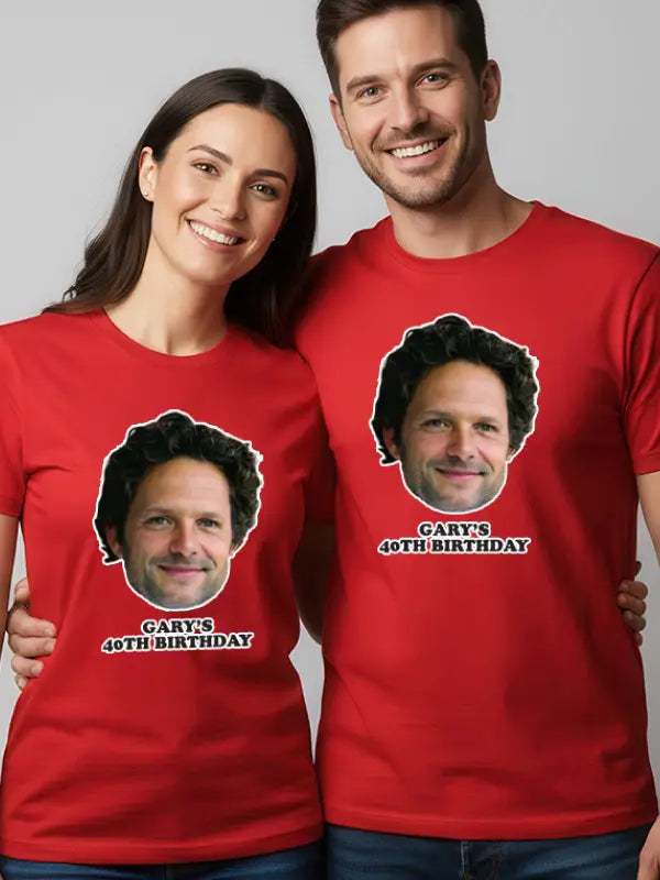 Smiling couple wearing red shirts with matching dtf iron on face transfers and birthday message printed below each face.