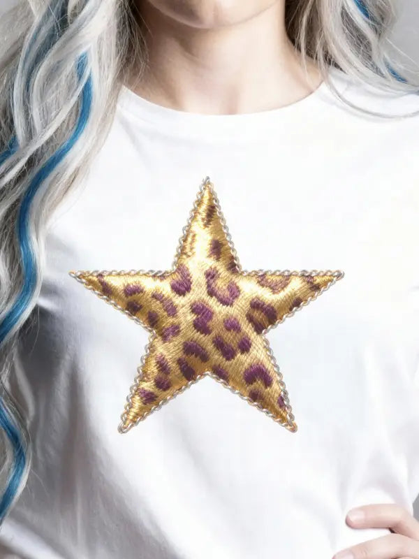 Leopard print iron on star transfer applied to the centre of a white T-shirt, showing how the embroidered star looks when worn.