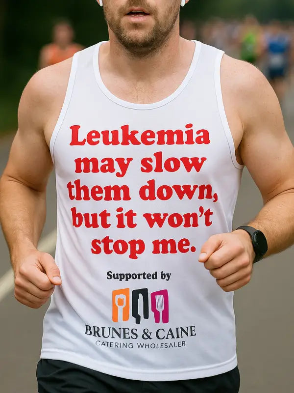 Man running in vest with iron on letters for marathon vest, reading “Leukaemia won’t stop me” in bold red text.
