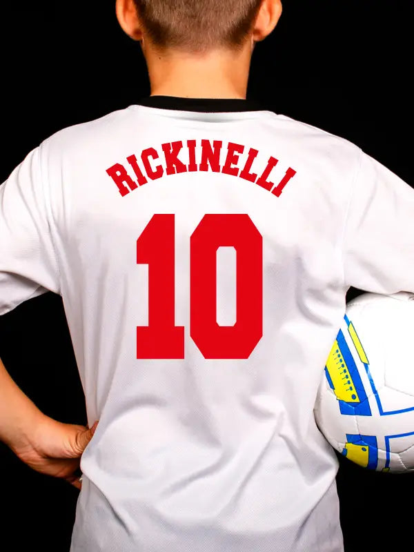 Boy in white football shirt with red name "RICKINELLI" and red number using football name and number iron on transfers.