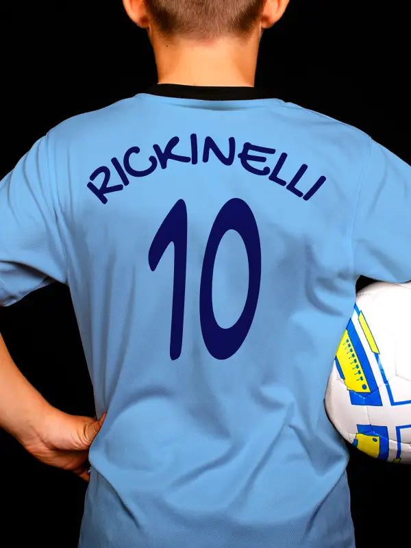Youth wearing football shirt with the name 'RICKINELLI' and number '10' in navy blue, applied using football name and number iron on transfers.
