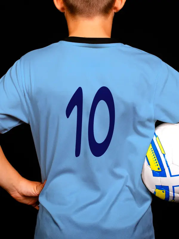 Youth wearing a light blue football shirt featuring the number '10' in navy blue, created using football name and number iron on transfers.