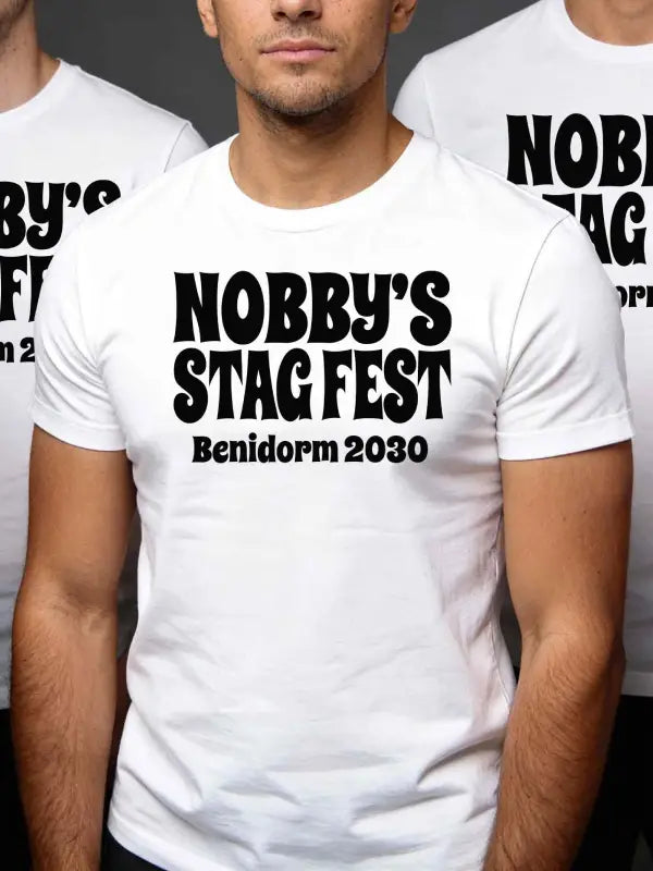 White t-shirt with 'Nobby's Stag Fest Benidorm 2030' text worn by a person.