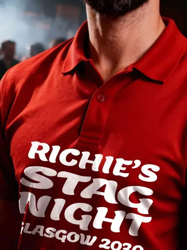 Red polo shirt with 'Richie's Stag Night Glasgow 2020' text worn by a person.