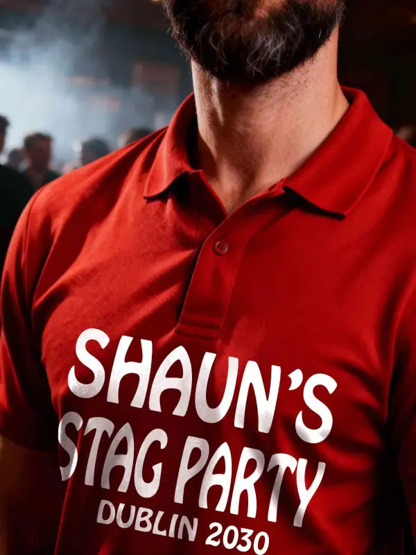 Red polo shirt with white iron on stag party transfer applied to the chest, showing a personalised party design worn on a night out.